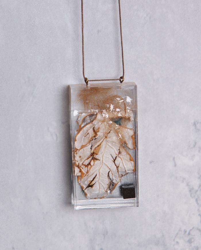 'leafing through' art object pendant