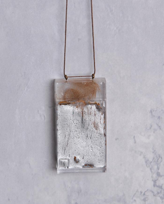 'leafing through' art object pendant